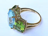 Elegant Three-Stone Ring with Gold Rope Twist Border with Blue Topaz and Peridot