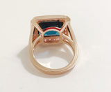Rose Gold Bezel Set Dark Blue Topaz with Surrounding Pink Sapphire Ring